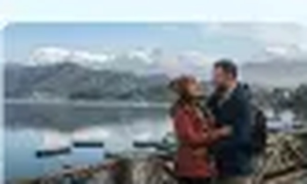 Couple by Pokhara lake with mountain view